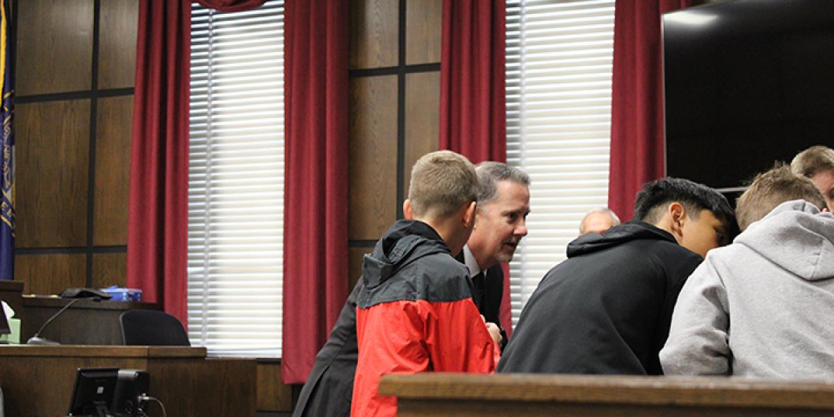 Justice Jeff Funke second from left, coaches students during morning 5th grade job shadow mock trial in Otoe County