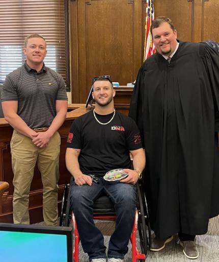 (left to right) Specialized Populations Officer Keefer Michel, graduate Kaden Clauff, and Judge Andrew Butler.