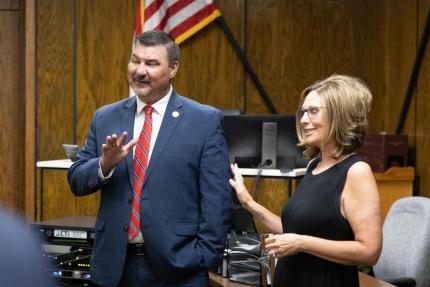 Hitchcock County Clerk Magistrate Linda Smith welcomes State Court Administrator Corey Steel to the courthouse.