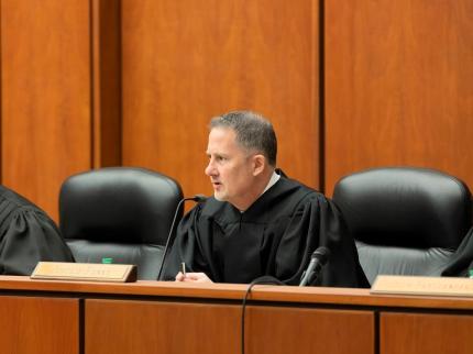 Justice Jeff Funke, Chair of the Bar Foundation’s Bench Media Committee, answers questions from Creighton students following law school argument session on April 3, 2024.