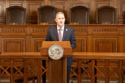 Chief Justice Funke at podium