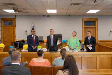 County Court Judge Joel Jay discusses the role of dual clerks before Pandora Garcia’s swearing-in.