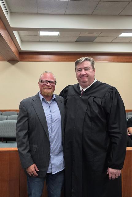 Photo: Judge Nathan Cox with graduate.
