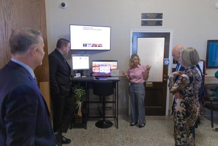 Perkins County Dual Clerk Kathy Woodmancy demonstrates the new videoconferencing technology to connect users with other courthouses.