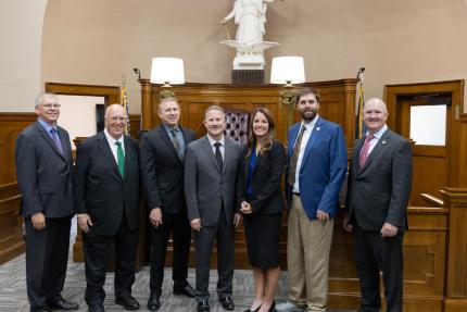 The tour concludes in Phelps County, from left to right: Justice John Freudenberg, Justice William Cassel, Judge Timothy Hoeft, Chief Justice Jeffrey Funke, Judge Natalie Nelson-Pacey, Judge Morgan Farquhar, and Justice Jason Bergevin.