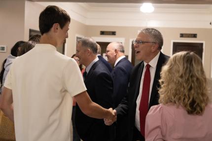 Justice John Freudenberg greets local high school mock trial team members.