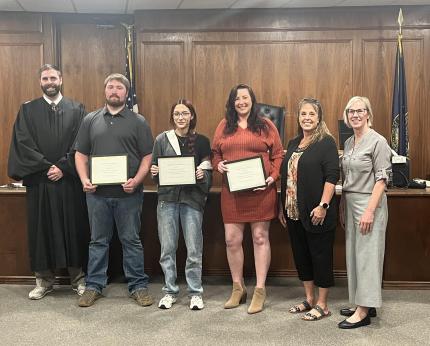 Photo: Judge Morgan Farquhar with graduates Corbin, Mariah, and Amanda; Supervision Officer Amy Norton; and Problem-Solving Court Coordinator Susan Huber.