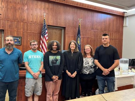 Photo: Judge Marroquin with the graduates.