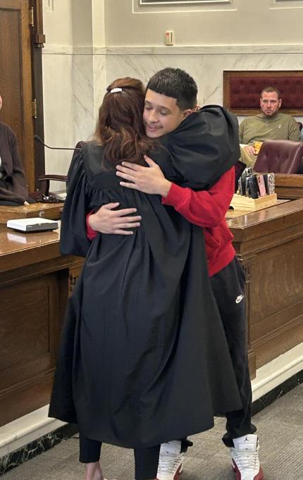 Judge Shelly Stratman congratulating Graduate Gabriel.