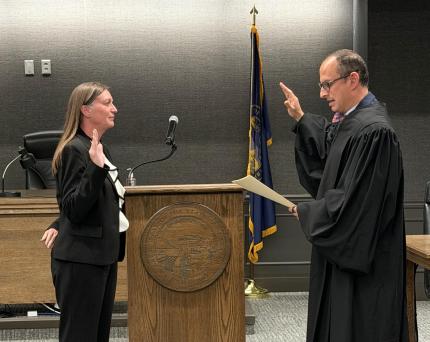 District Court Judge Horacio Wheelock administers the oath of office to Jennifer Finigan