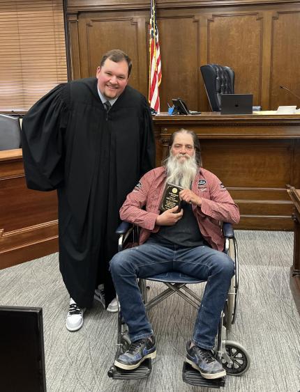 Photo: Judge Andrew Butler with graduate.