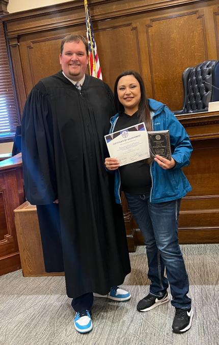 Judge Andrew Butler with graduate Rosangelica.