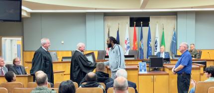 The graduates, Cortez and Cody, receiving their certificates.