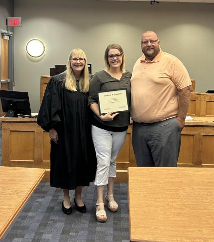 Photo: Judge Rachel Daugherty, graduate Courtney, and Problem-Solving Court Officer Kyle Hohnholt.