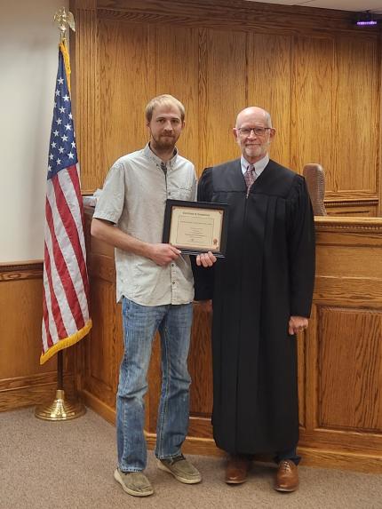 Photo: Judge Mark Kozisek with graduate.