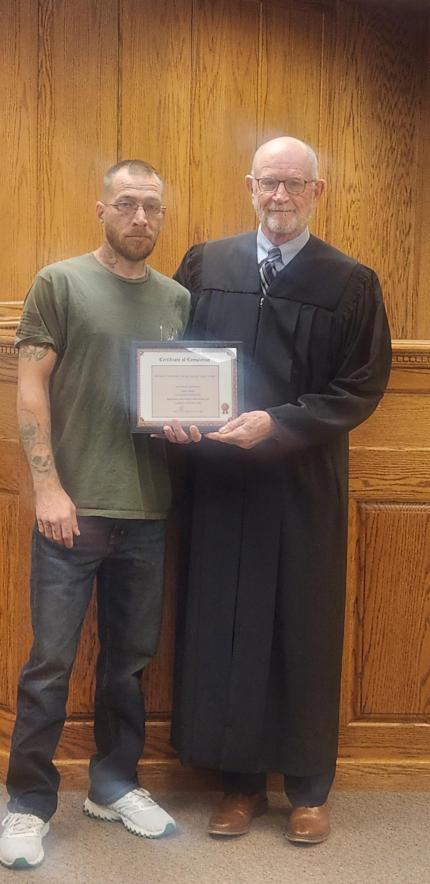 Judge Mark Kozisek with graduate.