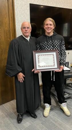 Photo: Judge James Kube and graduate Dawson.