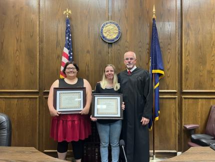 Photo: Graduate Schuyler, graduate Paige, and District Court Judge Kube. Not pictures is graduate Cody.