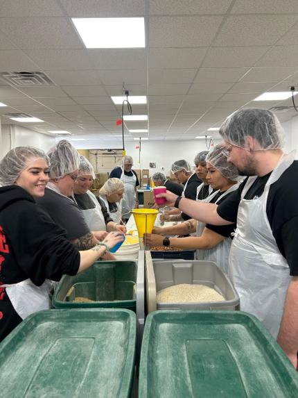 Members of the Northeast Nebraska Adult Drug Court collaborated to pack meals for distribution.