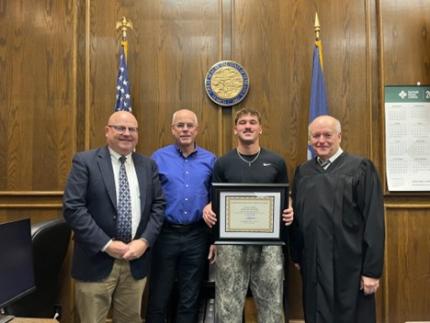 Photo (L to R): Defense Attorney Joel Carlson, Retired Judge James Kube, graduate Josiah, and Judge Mark Johnson