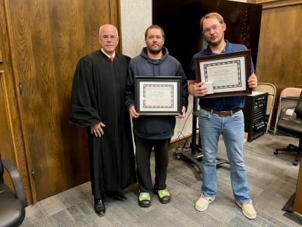 Photo: Graduates Jacob and Michael with Judge James Kube.