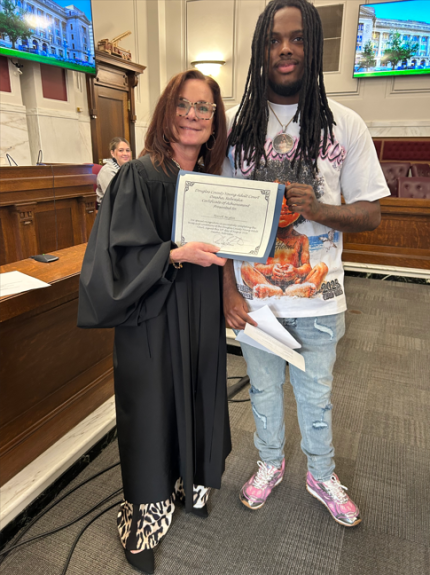 Top photo: Judge Shelly Stratman with graduate Terrell.