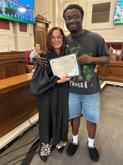 Bottom photo: Judge Shelly Stratman with graduate Tony.