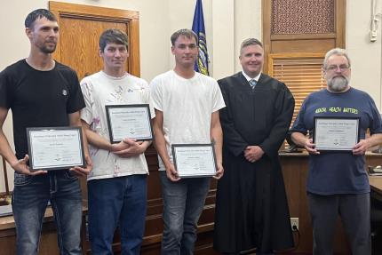 Top Photo: Judge Richard Smith with Graduates.