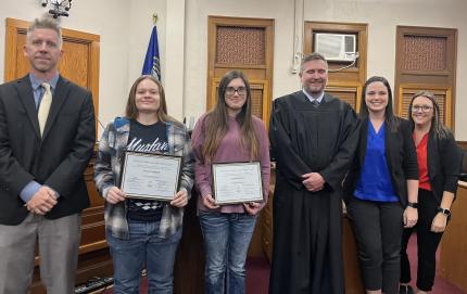Supervision Officers Marty Metschke and Chelsea Hagedorn, Judge Richard Smith, and Assistant Supervision Officer Chelsea Byfield with graduates.
