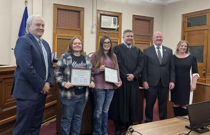 Probation Administrator Gene Cotter, Judge Richard Smith, Supreme Court Justice Jason Bergevin, and Chief Probation Officer Melanie Stormer with graduates.