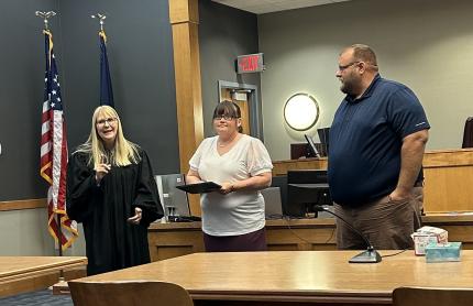 Top Photo: Judge Rachel Daugherty, Graduate Jetta, and Specialized Officer Kyle Hohnholt.