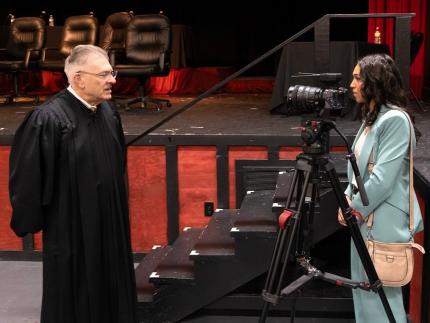 Chief Justice Mike Heavican interviewed by news reporter, Jill Lamkins, following April 3, 2024, Roncalli High School Supreme Court argument session.
