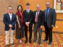 Photo (L-R): Teacher Coach Berkly Brummon, attorney coach Sandy Brown, student news reporter Landen Sharer, attorney coach Retired Judge Robert Ensz, and Teacher Coach Josh Johnson.